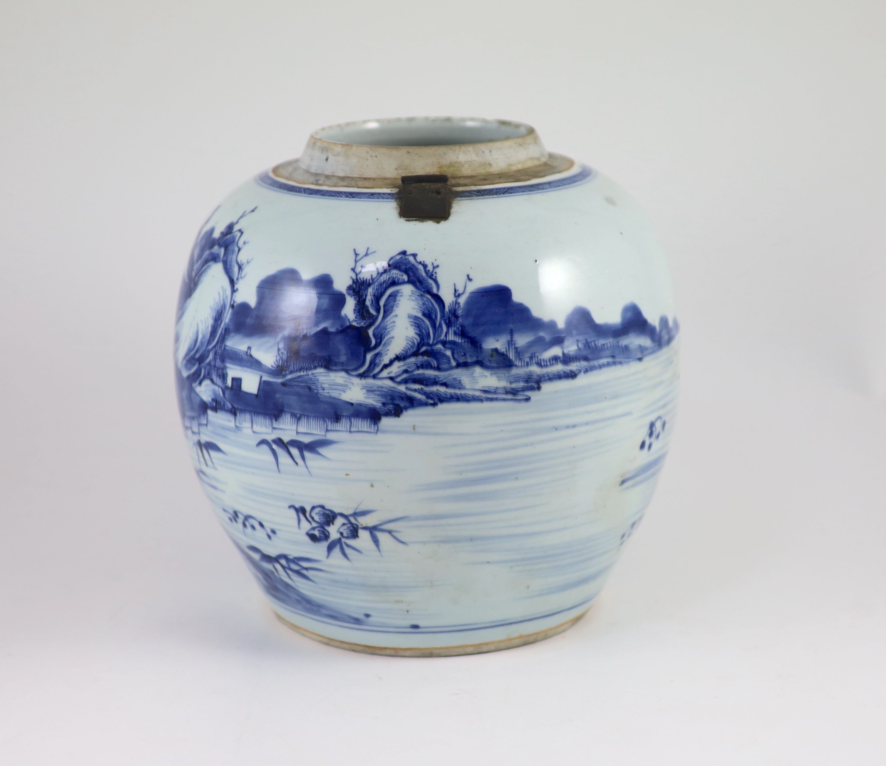 A Chinese blue and white jar and cover, Kangxi period (1662-1722), 23cm high, metal fittings attached to shoulder, Cover repaired and not the best fit